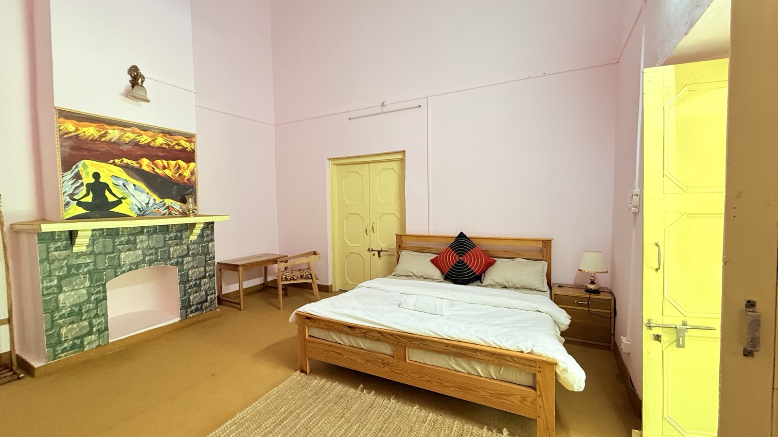 Room with stone fireplace and art